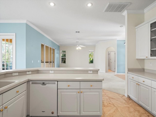 kitchen featuring white dishwasher, white cabinetry, a healthy amount of sunlight, and crown molding