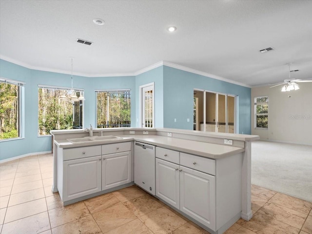 kitchen featuring white cabinets, white dishwasher, plenty of natural light, and hanging light fixtures