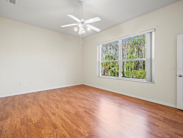 empty room featuring ceiling fan and light hardwood / wood-style flooring