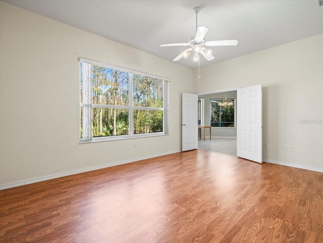 unfurnished room with hardwood / wood-style floors and ceiling fan