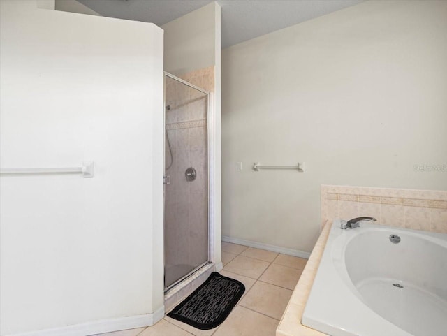 bathroom featuring separate shower and tub and tile patterned floors