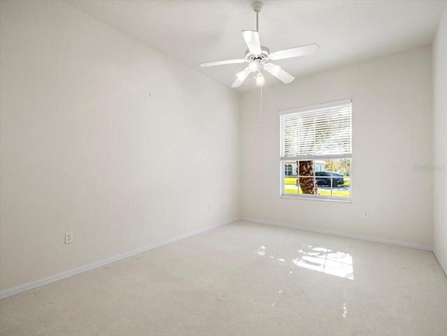 empty room featuring light carpet and ceiling fan