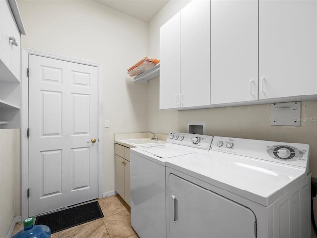 washroom featuring cabinets, light tile patterned flooring, washer and clothes dryer, and sink