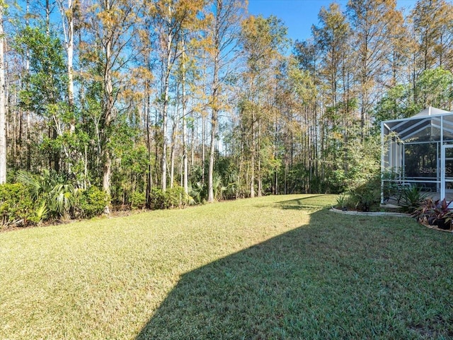 view of yard with glass enclosure