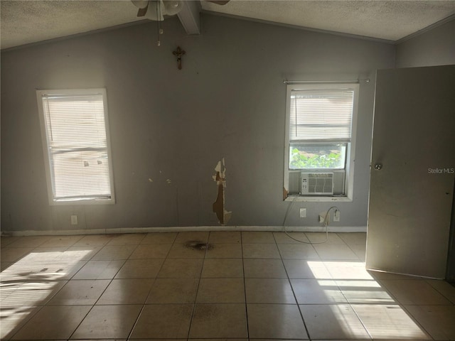 empty room featuring lofted ceiling with beams, cooling unit, ceiling fan, a textured ceiling, and light tile patterned flooring