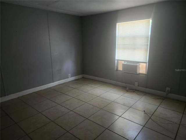 spare room with cooling unit and light tile patterned flooring