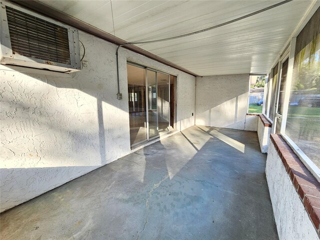 view of patio featuring a wall unit AC