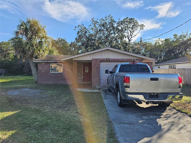 single story home featuring a front lawn and a garage