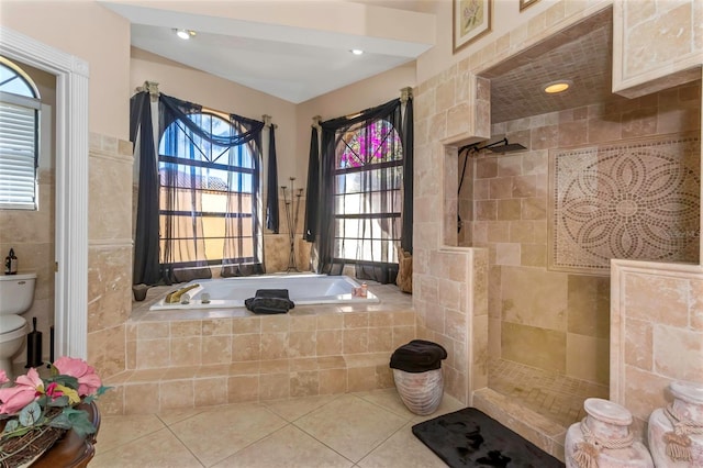 bathroom with tile patterned flooring, a healthy amount of sunlight, tile walls, and shower with separate bathtub