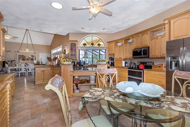 dining room featuring ceiling fan and vaulted ceiling