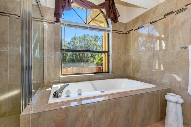 bathroom featuring tiled tub