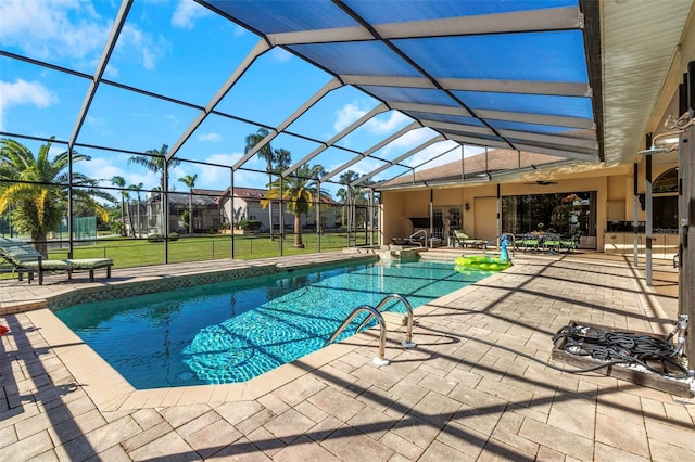 view of pool featuring a yard, a patio area, ceiling fan, and a lanai