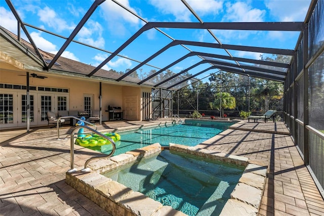 view of swimming pool featuring glass enclosure, french doors, a patio, and grilling area