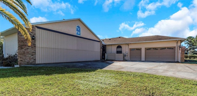 view of front of property with a front yard and a garage