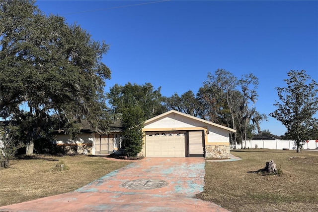 ranch-style home with a front yard and a garage