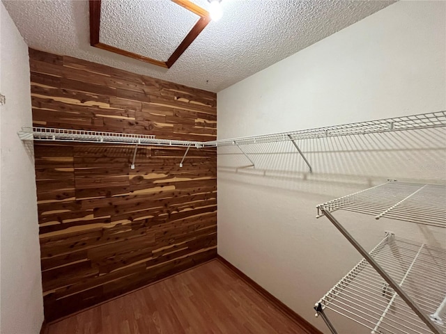 spacious closet featuring hardwood / wood-style flooring