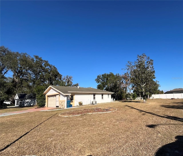 single story home with a front yard and a garage