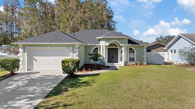 view of front of house featuring a front yard and a garage