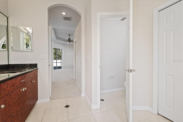 bathroom with ceiling fan, tile patterned flooring, vanity, and toilet