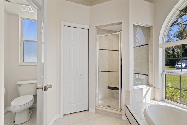 bathroom featuring tile patterned floors, toilet, and plus walk in shower