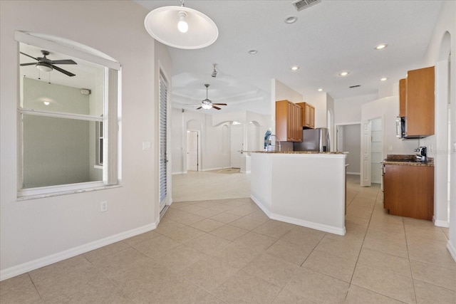 kitchen with ceiling fan, light tile patterned floors, hanging light fixtures, and appliances with stainless steel finishes