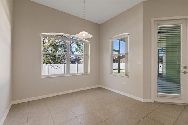 unfurnished room with plenty of natural light and light tile patterned flooring