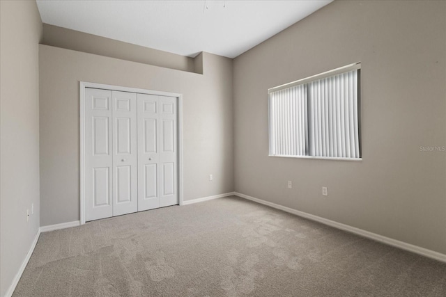 unfurnished bedroom with carpet flooring and a closet