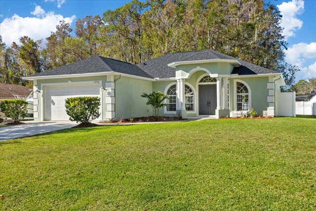 ranch-style house featuring a garage and a front yard