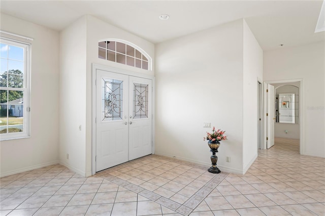 foyer entrance featuring french doors and light tile patterned flooring