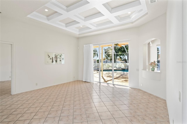 tiled empty room with beamed ceiling, a towering ceiling, and coffered ceiling