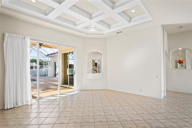 empty room with beamed ceiling, light tile patterned floors, and coffered ceiling