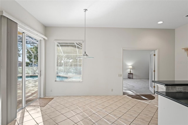 unfurnished dining area featuring light tile patterned flooring