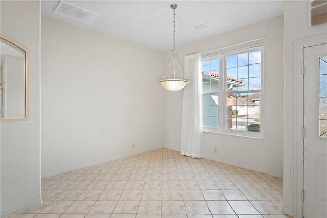 unfurnished dining area featuring light tile patterned floors