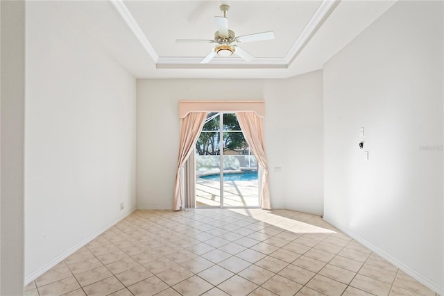 empty room featuring a tray ceiling, ceiling fan, crown molding, and light tile patterned flooring