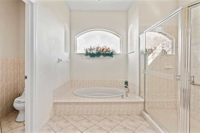 bathroom with tile patterned flooring, toilet, and plus walk in shower