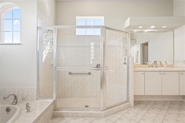 bathroom featuring tile patterned flooring, vanity, and separate shower and tub