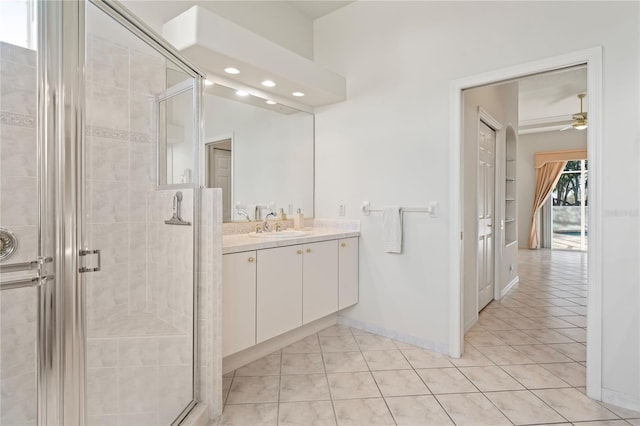 bathroom with tile patterned flooring, vanity, ceiling fan, and a shower with shower door