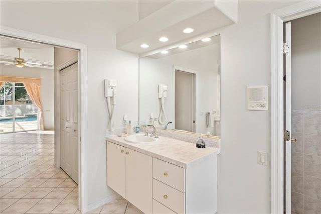 bathroom featuring tile patterned floors, ceiling fan, and vanity