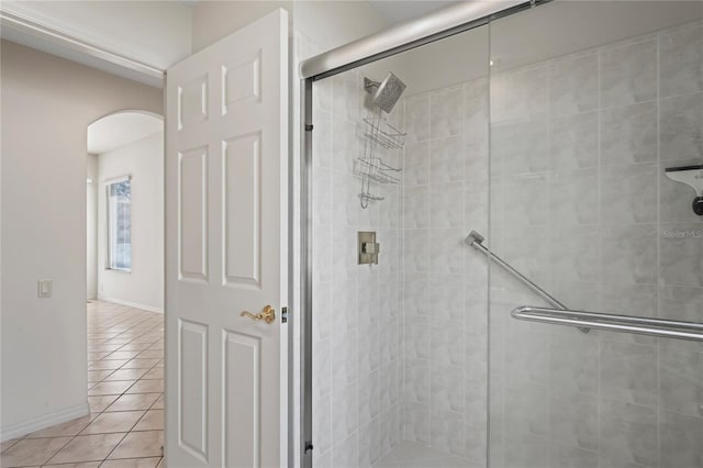 bathroom featuring tile patterned floors and a shower with shower door