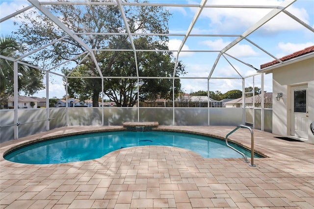 view of pool featuring a patio and glass enclosure