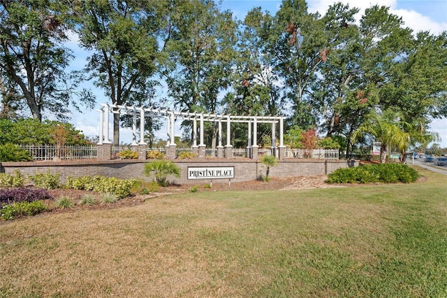 exterior space with a pergola and a lawn