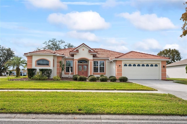 mediterranean / spanish house with a front lawn and a garage