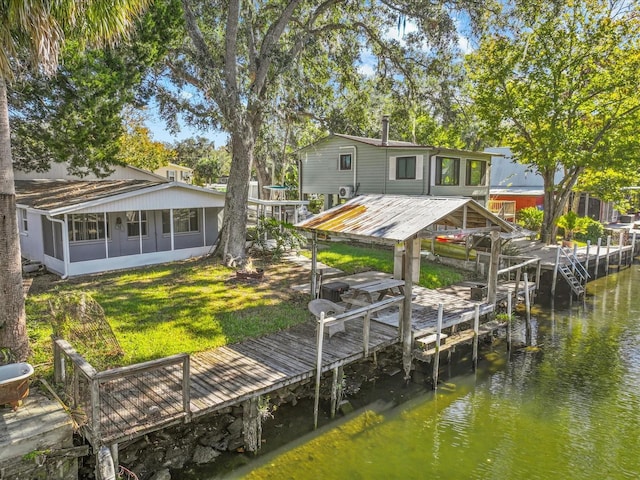 dock area featuring a water view and a lawn