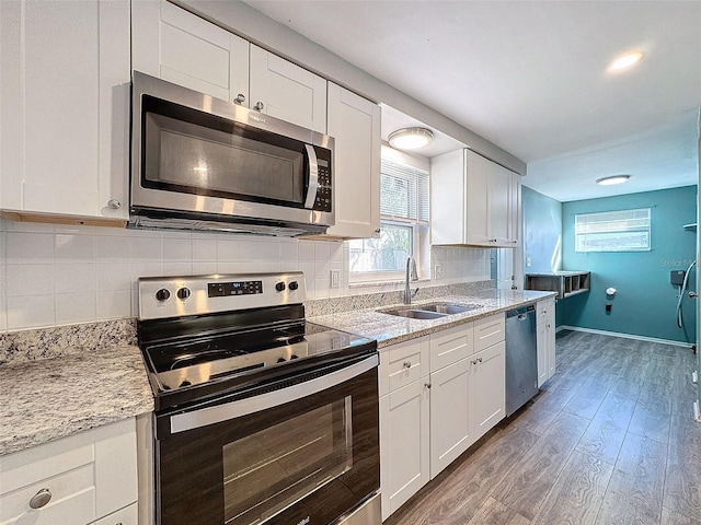 kitchen featuring white cabinetry, sink, dark hardwood / wood-style floors, and appliances with stainless steel finishes