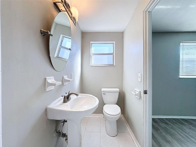 bathroom featuring hardwood / wood-style floors, toilet, and a wealth of natural light