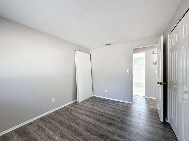 unfurnished room with dark hardwood / wood-style floors