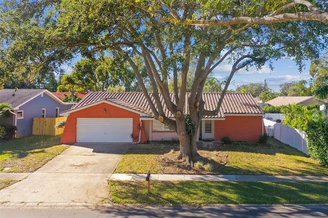 ranch-style house featuring a front yard and a garage