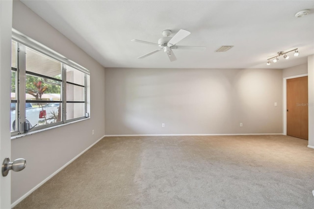 unfurnished room featuring visible vents, a ceiling fan, carpet, and baseboards
