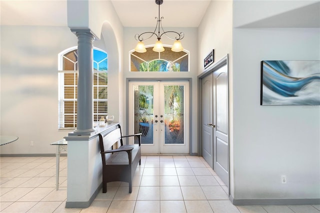 5211 Karlsburg Pl, Palm Harbor, FL 34685 - entryway with french doors, decorative columns, light tile patterned flooring, and arched walkways