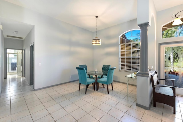 tiled dining room featuring decorative columns